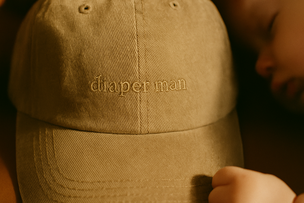 Diaper Man hat — tonal embroidery detail on khaki dad hat