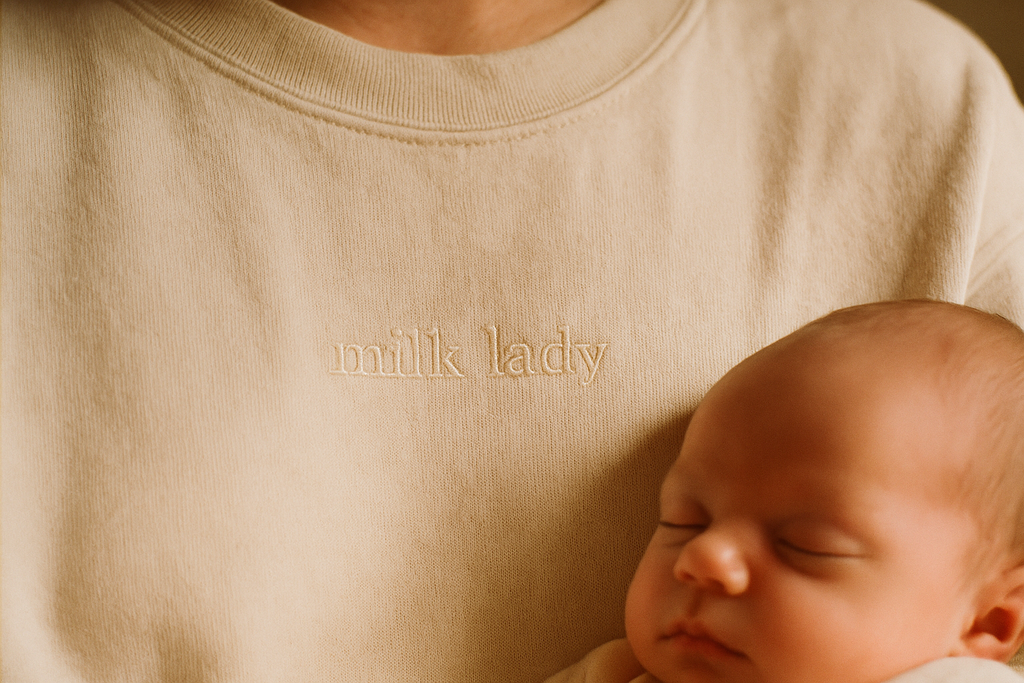 Milk Lady — chest detail, tonal embroidery on ivory sweatshirt